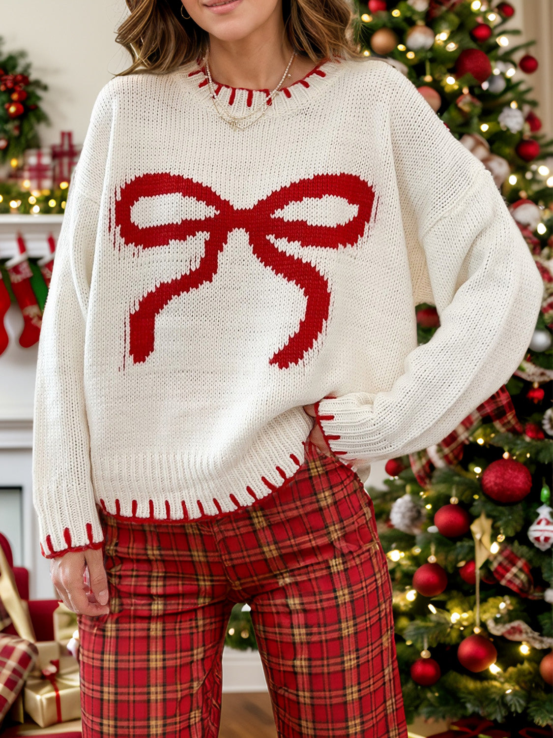 Cozy white sweater with red bow design, perfect for winter season outfits and online shopping.