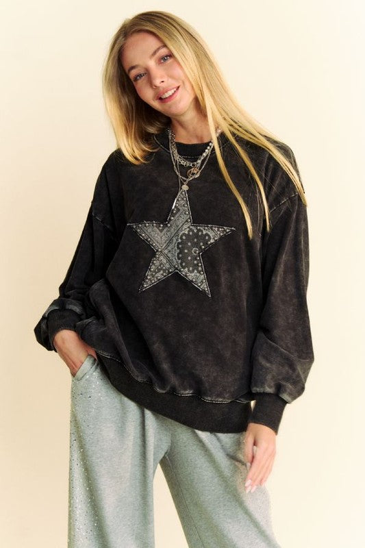 Trendy acid washed sweatshirt with stud star patch, perfect for a stylish rock 'n' roll look.