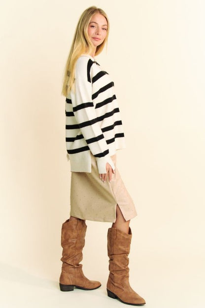 Model wearing Davi & Dani high-low striped Johnny collar sweater with stylish side slits and knee-high boots.