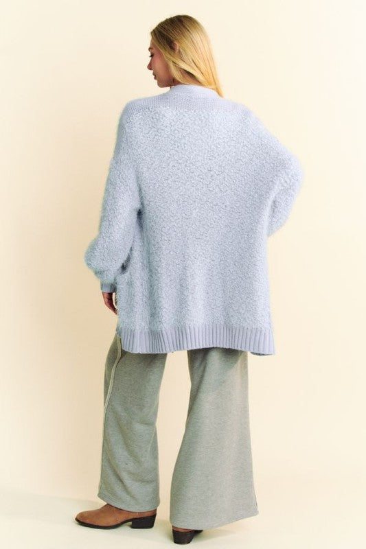 Back view of a soft blue fuzzy sweater paired with gray knit pants, perfect for winter fashion and cozy style.