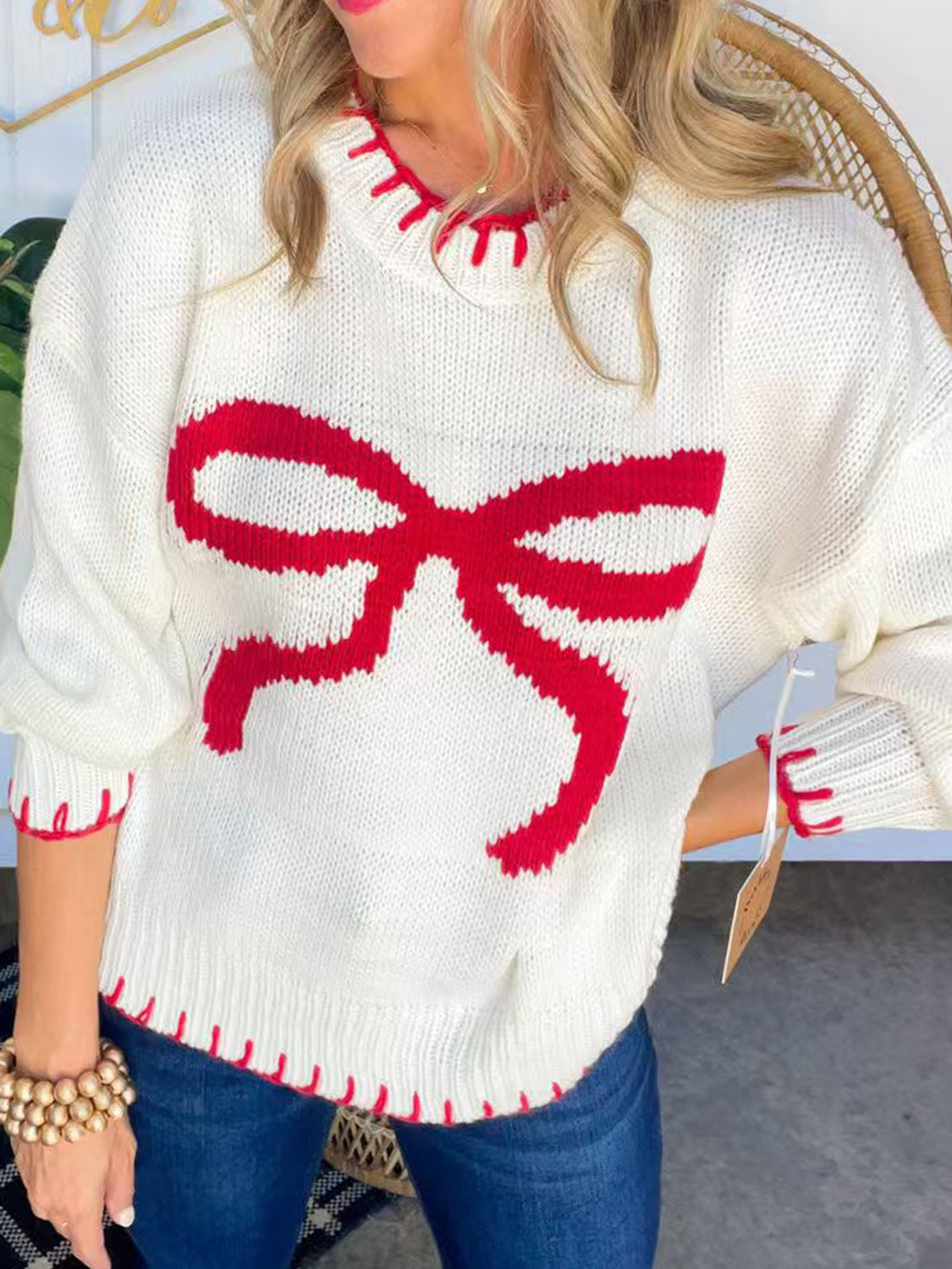 Stylish white bow round neck sweater with red accents, perfect for winter fashion and online shopping.