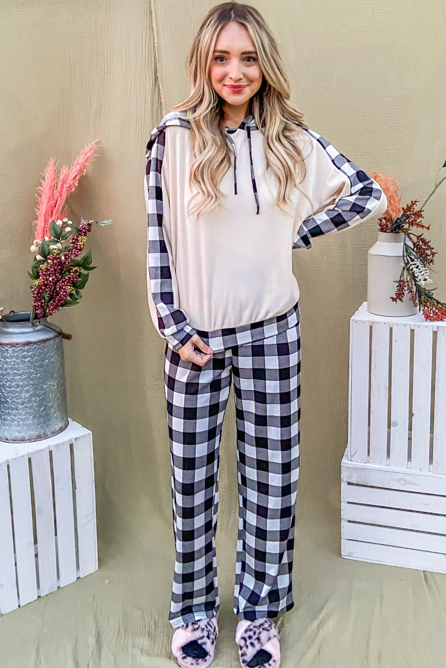 Trendy woman in drawstring hooded top and plaid pants lounge set, perfect for stylish lounging or running errands.