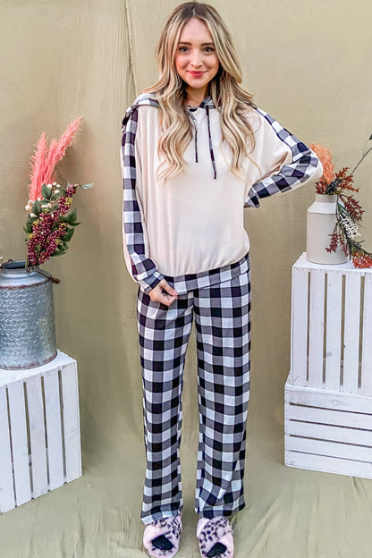 Trendy woman in drawstring hooded top and plaid pants lounge set, perfect for stylish lounging or running errands.