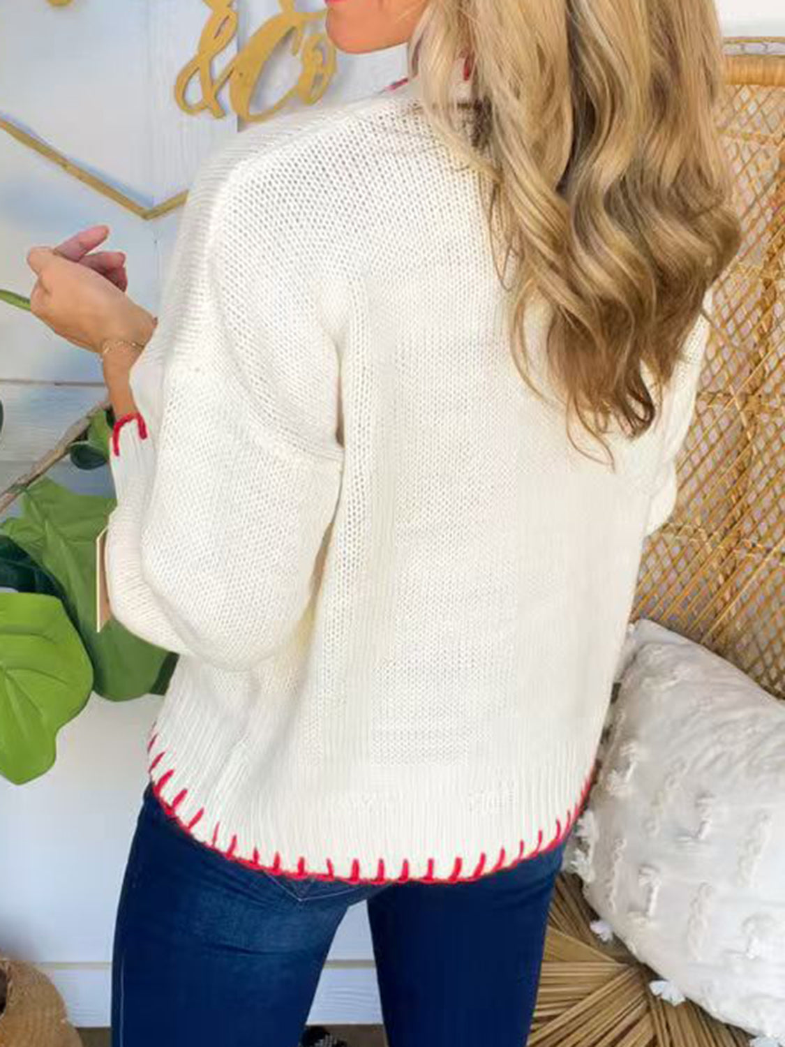 Back view of a stylish white bow round-neck long sleeve sweater with red trim, perfect for winter season online shopping.