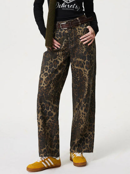 Leopard straight jeans with pockets, featuring a buttoned design, styled with a black top and casual shoes.