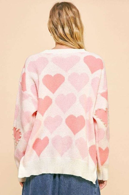 Back view of Davi & Dani heart pearl side slit V-neck sweater with pink heart patterns and cozy fit.