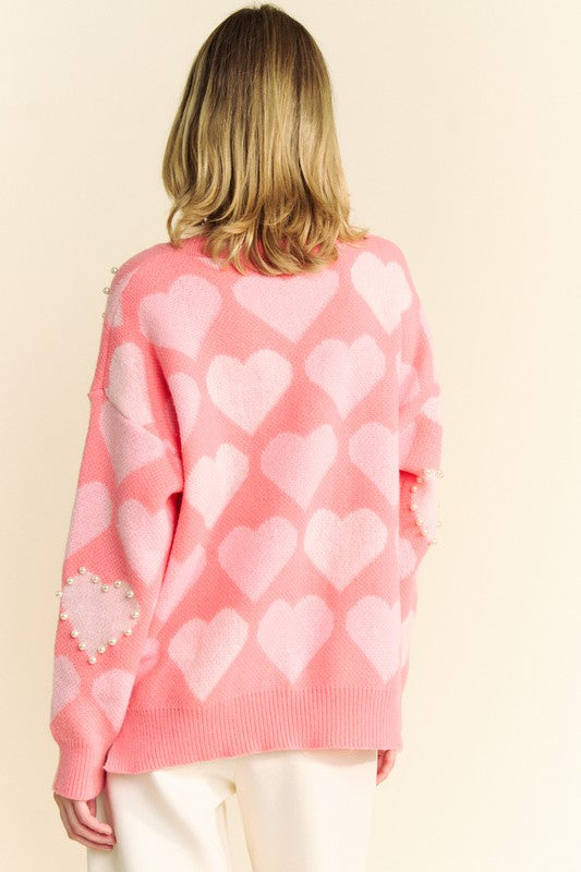 Back view of Davi & Dani pink heart pearl side slit V-neck sweater with playful heart pattern and pearl embellishments.