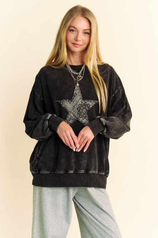 Trendy Davi & Dani acid washed sweatshirt with stud star patch worn by a model, showcasing a stylish, edgy look.